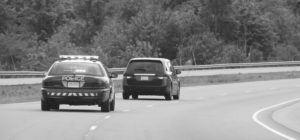 Police car Chasing speeder in black and white