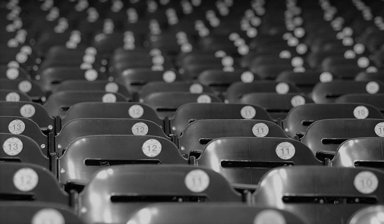 Rows of empty, numbered baseball stadium seats