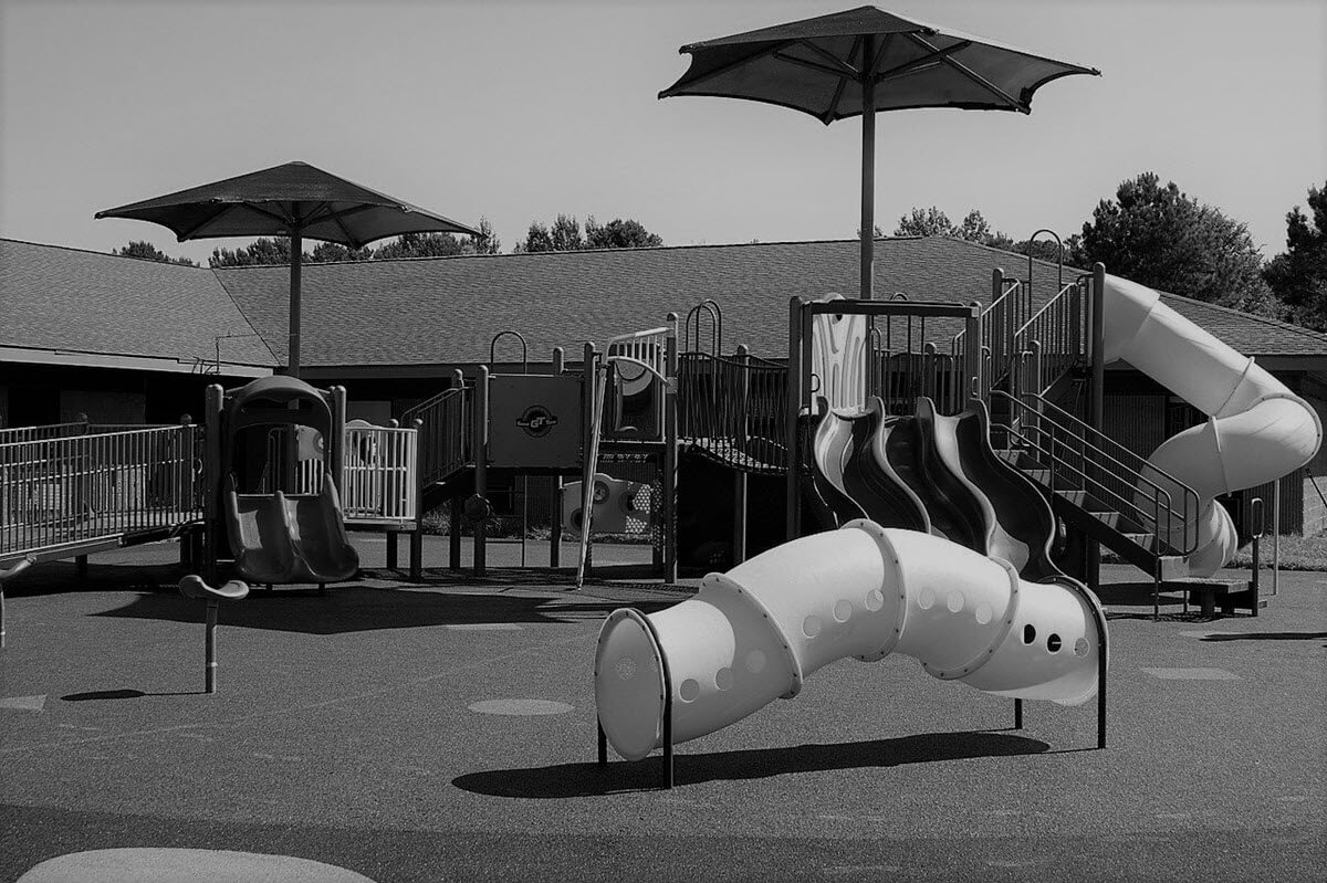 A Children's Playground with umbrellas and slides