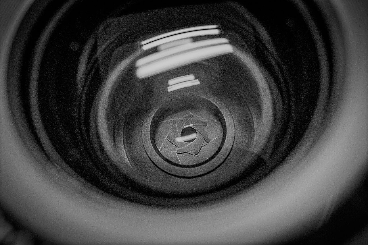 Close up of Camera Lens and Aperture Focused on Alphabet