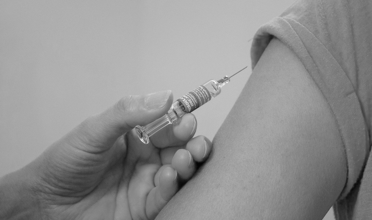 A doctor testing a vaccination shot on patient