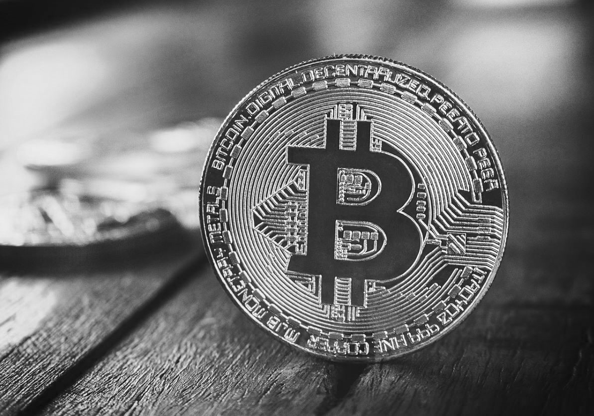 Bitcoin close-up on wood grain in black and white