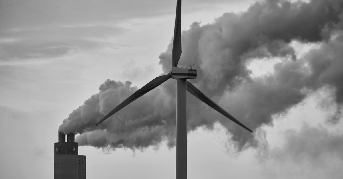 Wind turbine near a Factory: Eco-friendly power source, reducing emissions