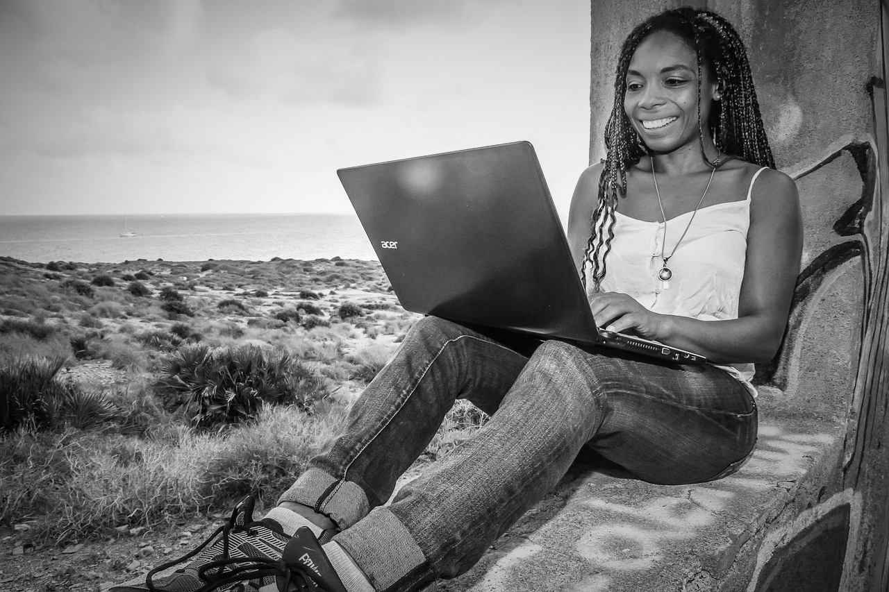 Happy woman working remotely on laptop, despite the Great Resignation