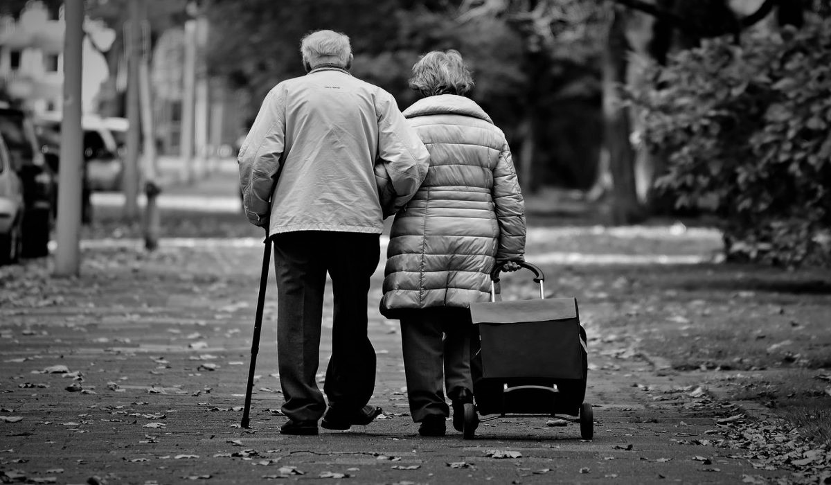 Elderly Couple walks together, Overcoming Recession