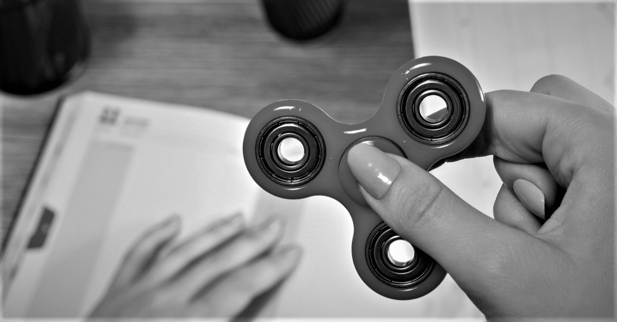 Person using a fidget spinner