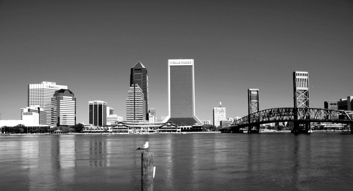 Jacksonville, FL city skyline with view of river and bridge