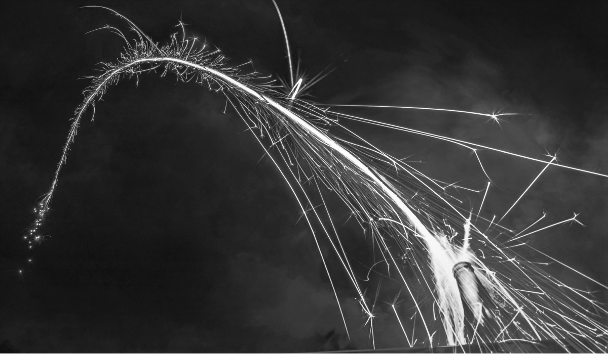 Rocket Fireworks Bottle Arching through Night