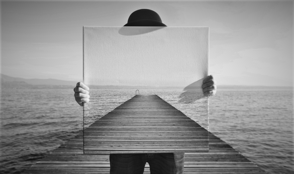 Optical illusion of a person standing on a pier, holding a canvas painting of the pier in front of them so as to appear invisible