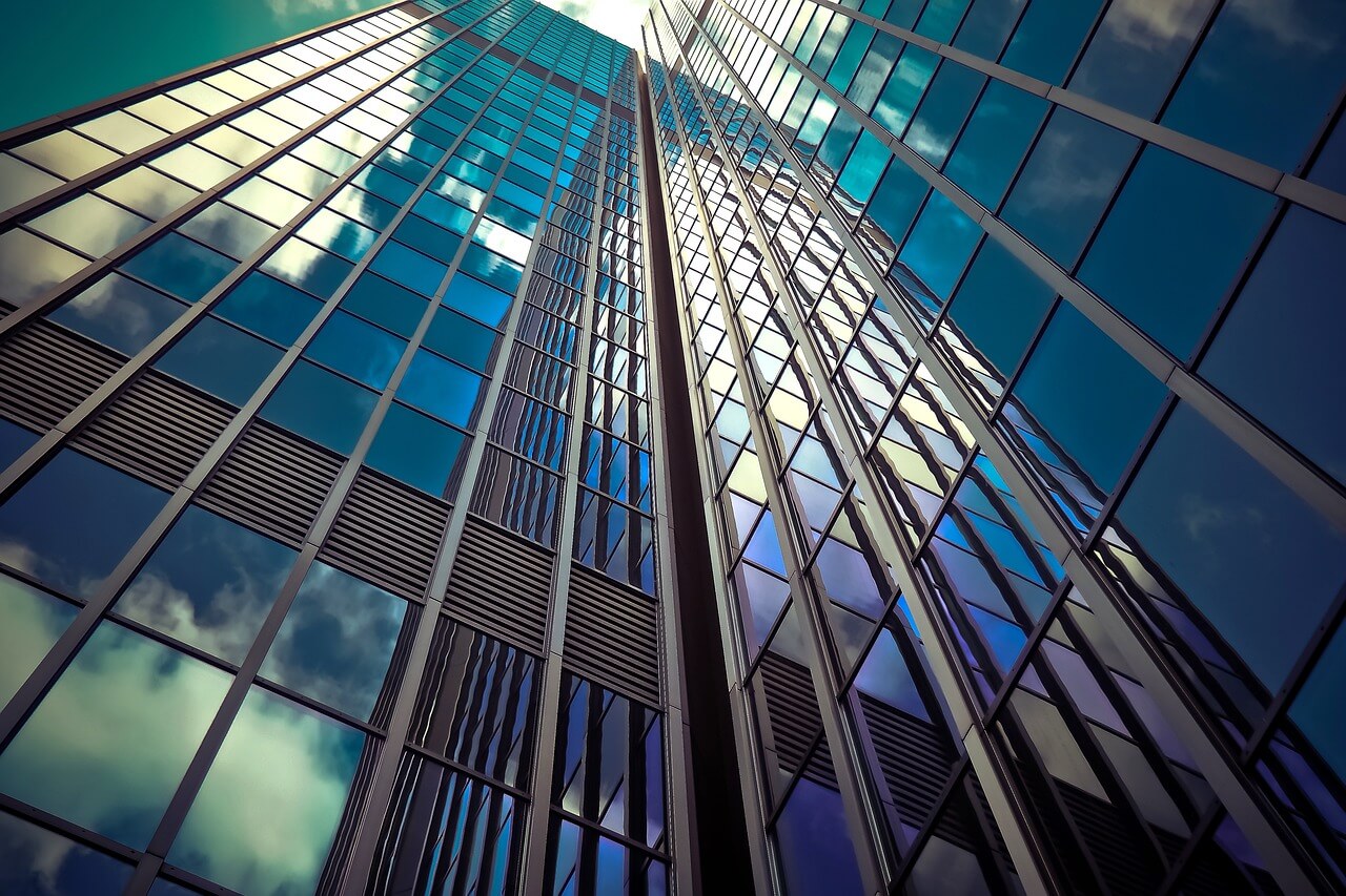 Close up looking up at office buildings with dark windows