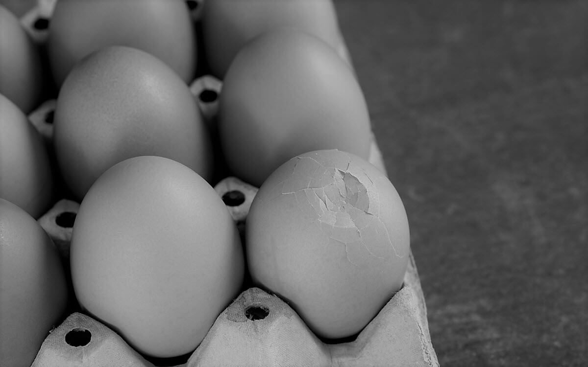 Carton of eggs with one cracked