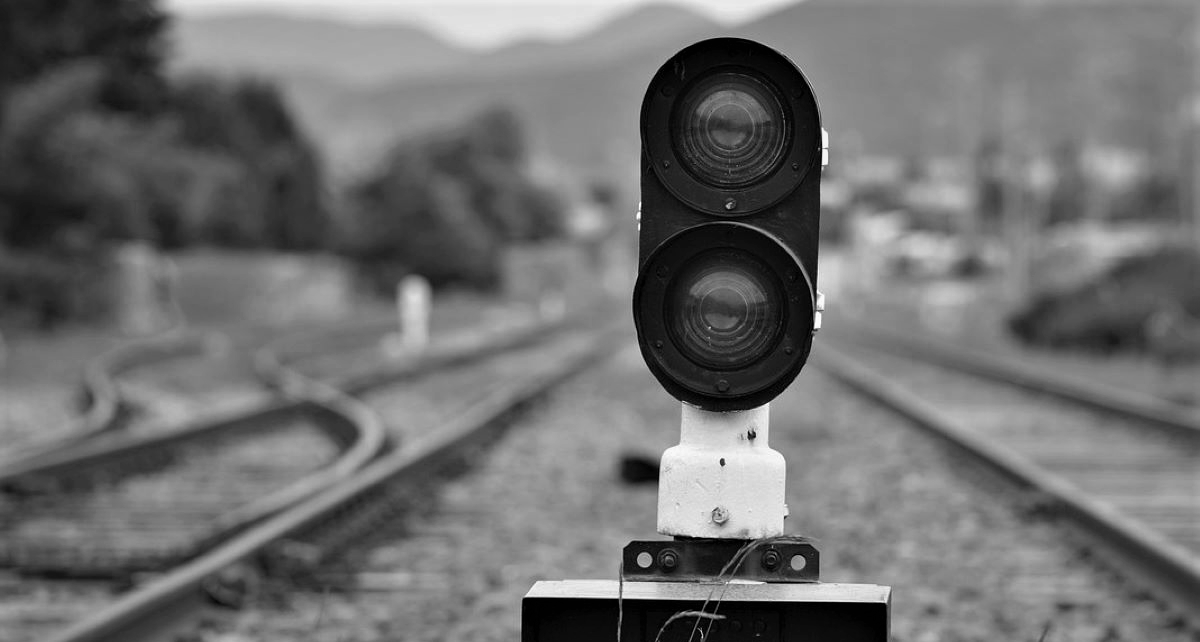 Railway signals in the middle of railroad tracks, symbolizing insider trading