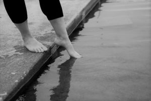 woman dips toe in water