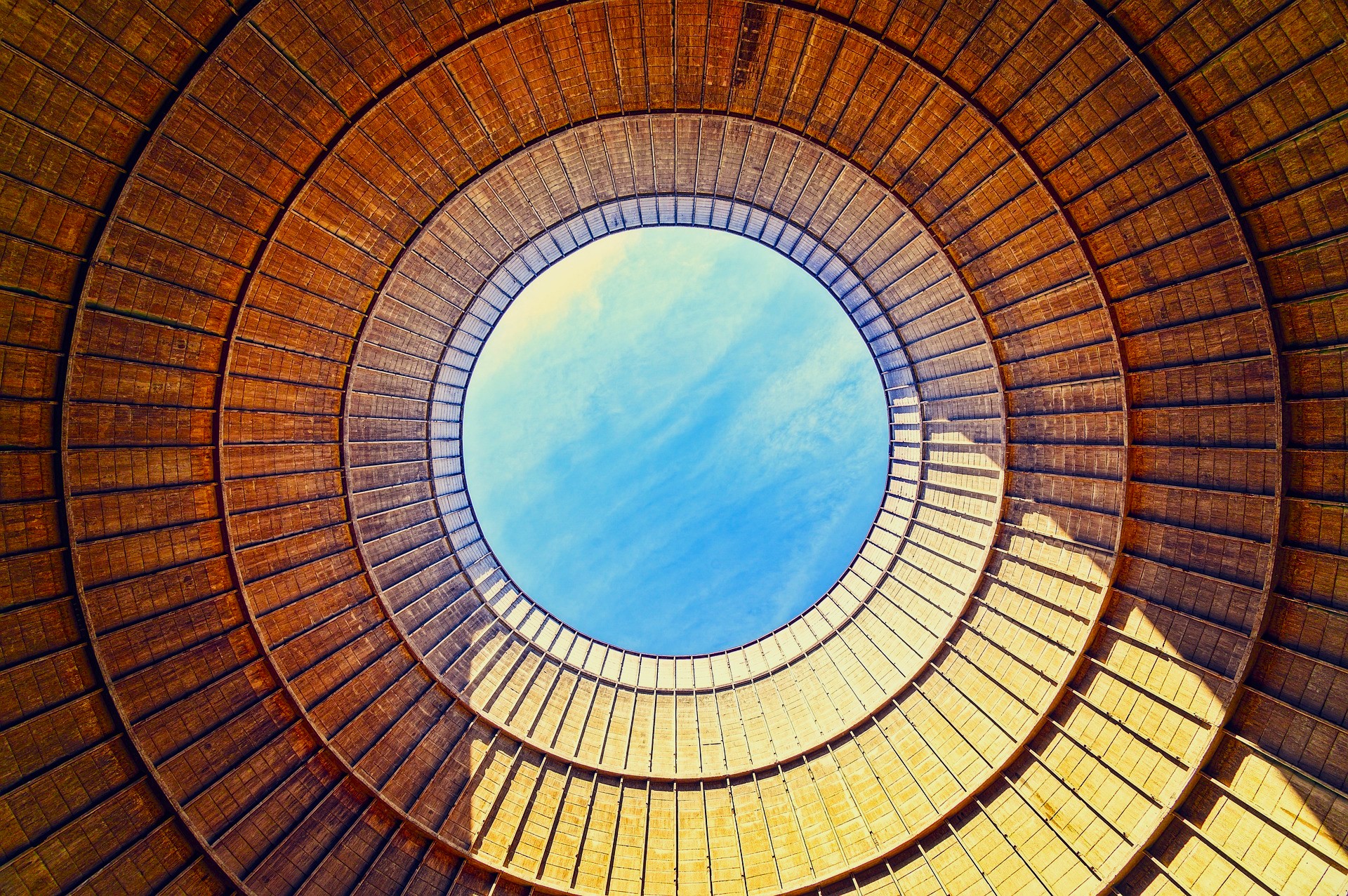 View looking up at the sky from the inside of a cooling tower
