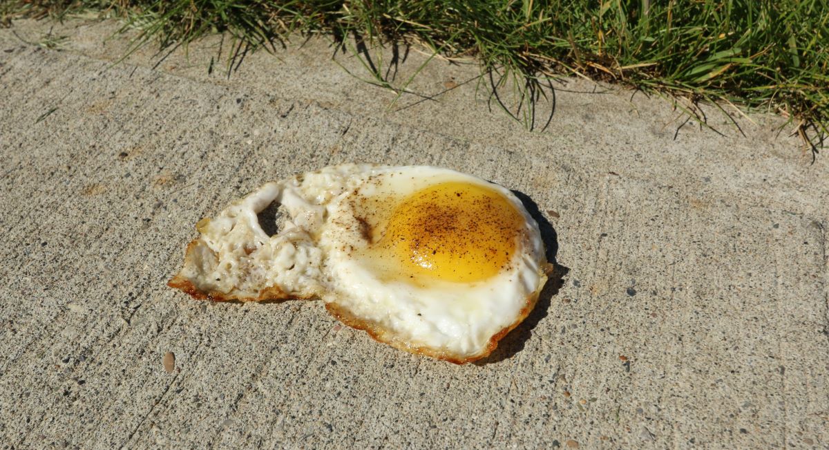 Fried egg on a sidewalk