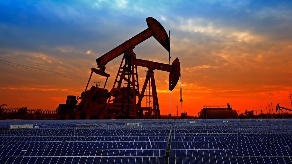 Solar panels with backdrop of oil drills: An ESG Debate