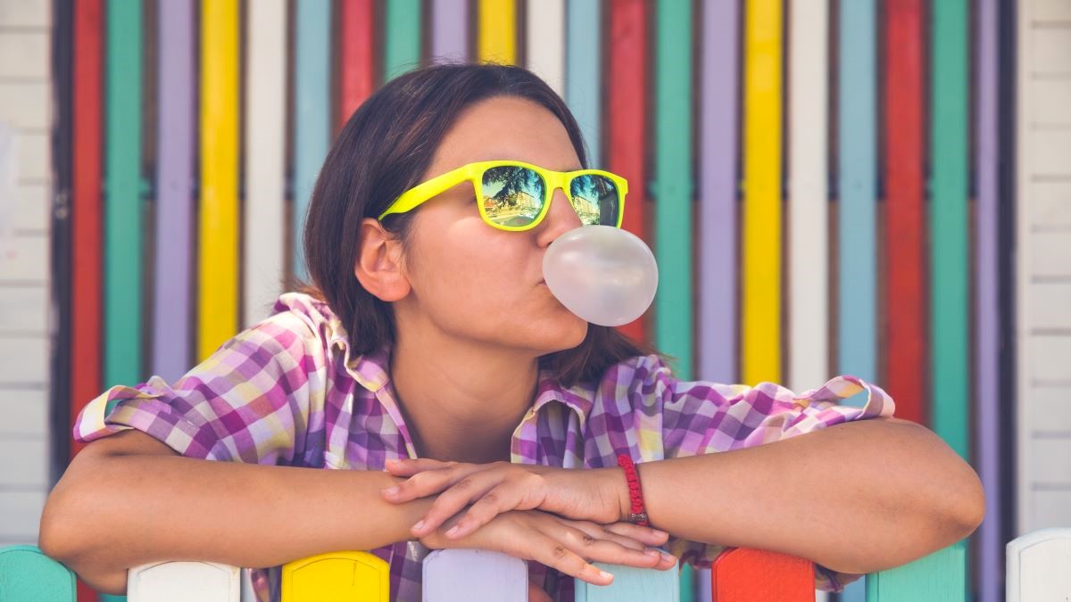 Young woman blowing bubblegum