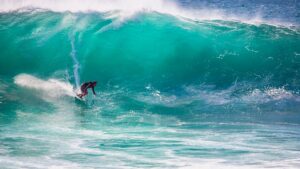 Person surfing on large wave