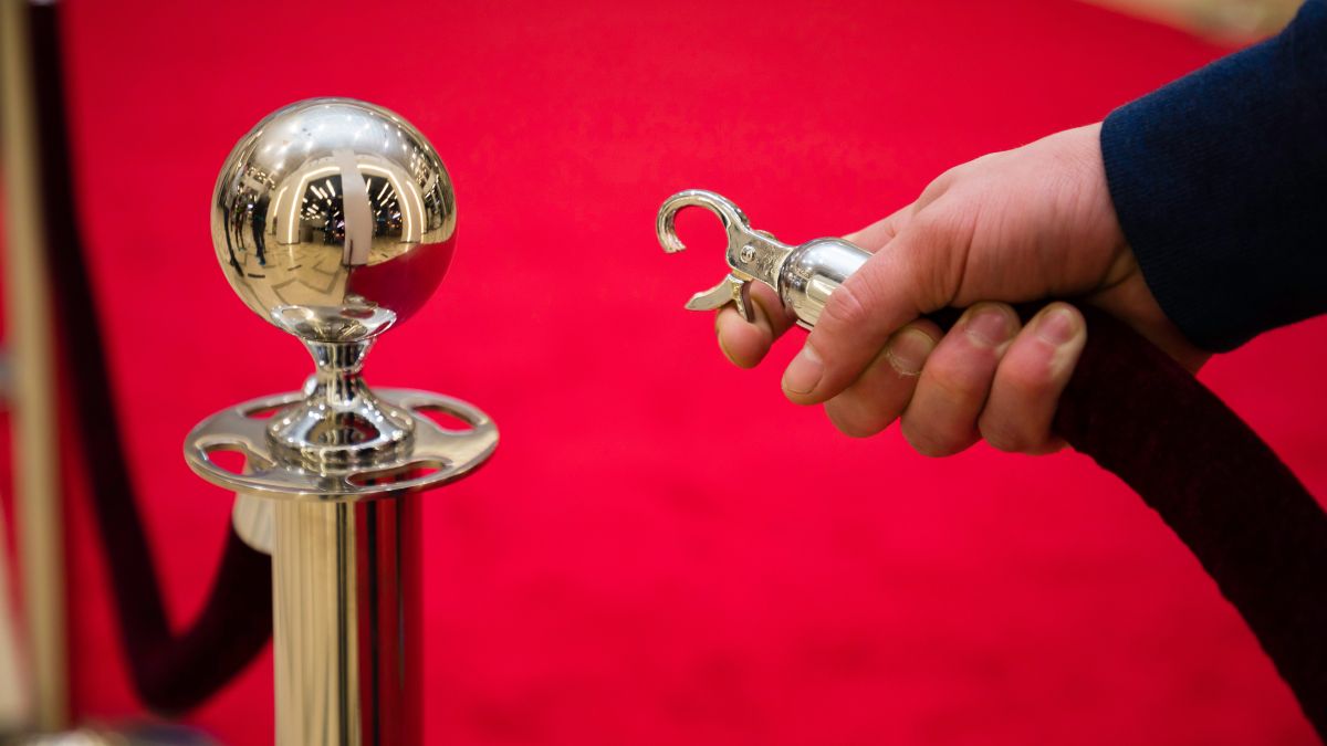 rope barricade on red carpet limiting entry