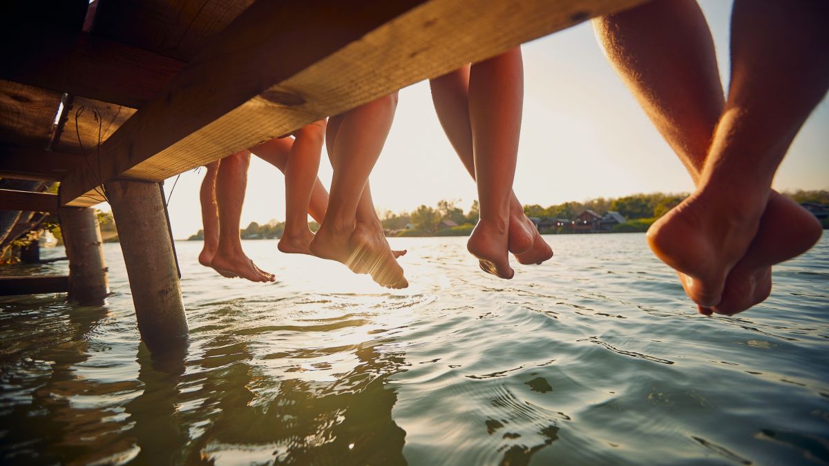 row of feet dangling from dock