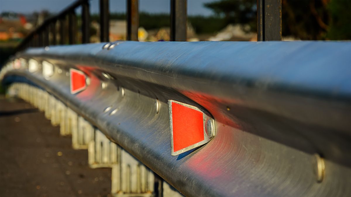 guardrail lining a busy road