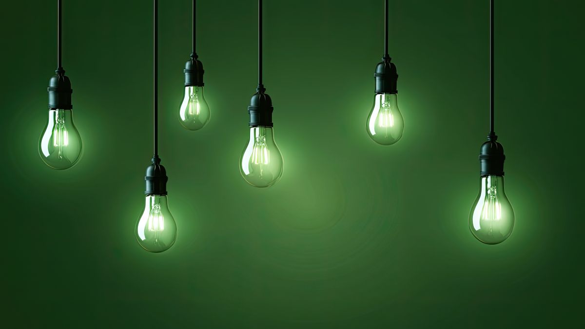 six light bulbs dangling in front of green background